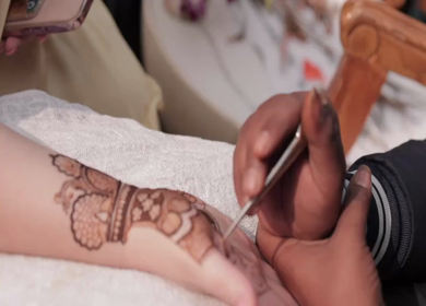 A Slow Motion Shot of Applying Mehndi on Bride's hand at her Indian Wedding in India