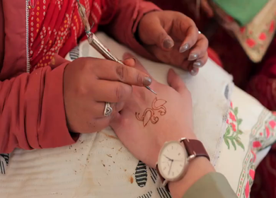 A Slow Motion Shot of Applying Mehndi on Bride's hand at her Indian Wedding in India