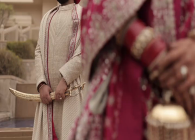 A Slow motion shot of a Indian Groom and Indian Bride posing towards camera at their Indian wedding in India